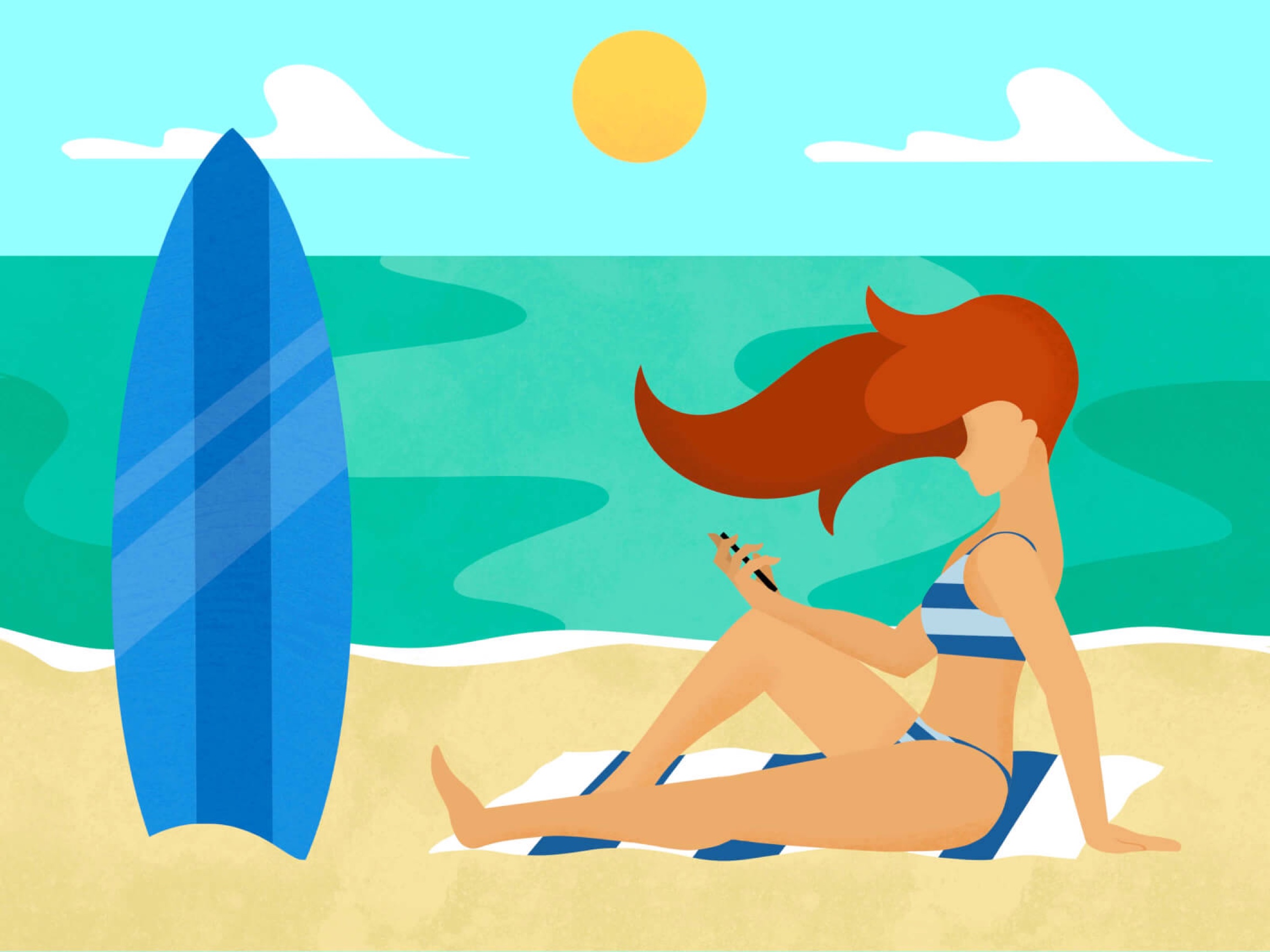 Woman looking at her phone on the beach.